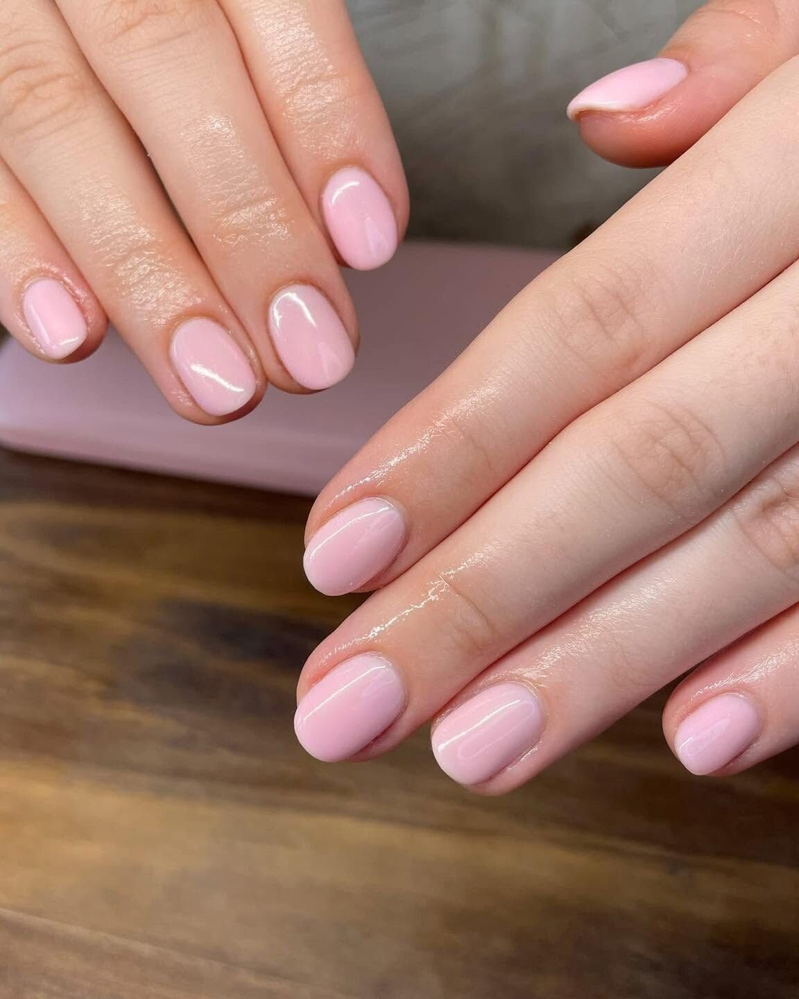 Glossy baby pink gel manicure on short rounded nails