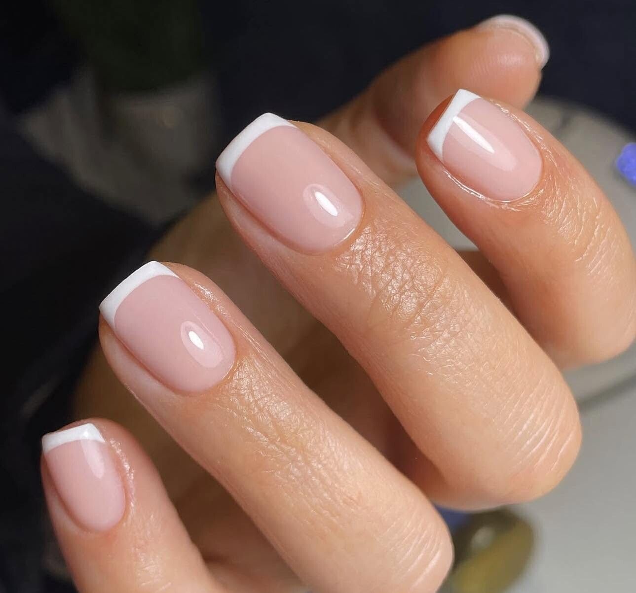 Classic French manicure with crisp white tips on a sheer nude base