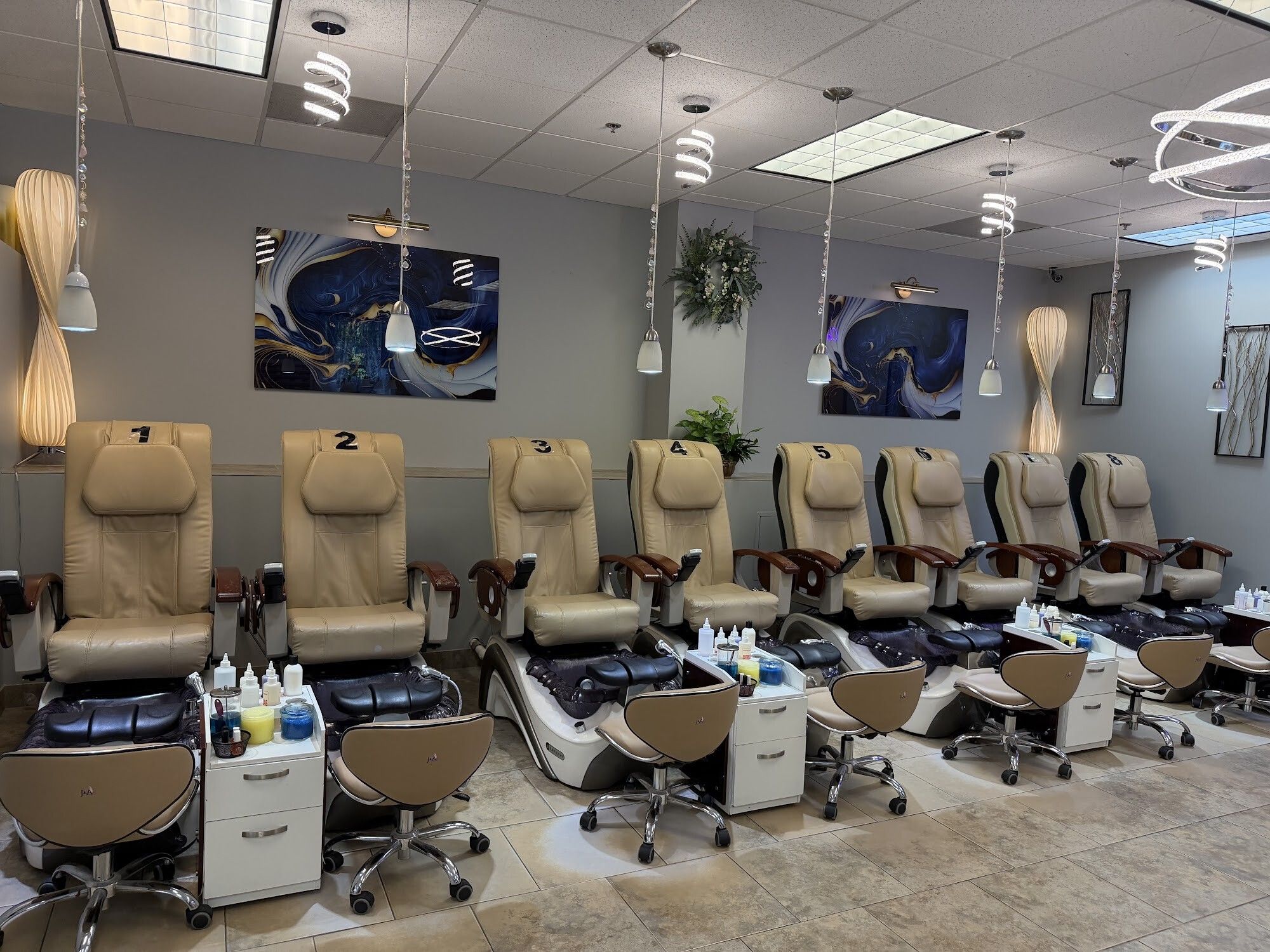 Bright pedicure lounge with massage spa chairs at Christine’s Nails Hopkinton